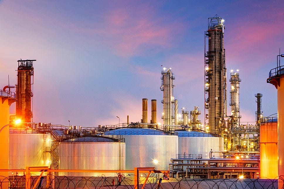 Oil refinery with storage tanks at twilight